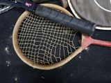 a tennis racket and a tennis ball on a table