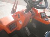 an orange tractor with a steering and a steering wheel