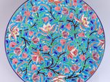 a blue and pink plate with a floral design on it