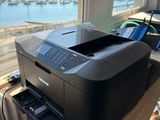 the printer is sitting on the table by the window