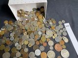 a box full of coins sitting on a table next to a ruler