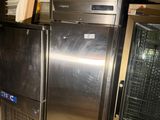 stainless steel refrigerators and freezers in a kitchen with tile flooring