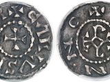 an image of two silver coins, one of which has a design on it