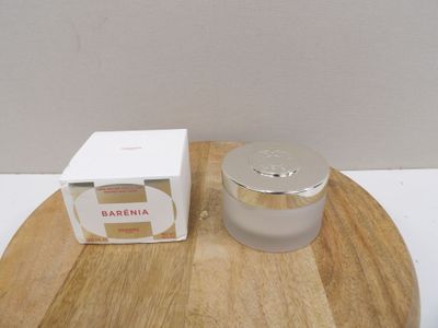 a picture of a jar of cream sitting on a wooden tray