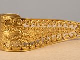 a close up of a gold plated metal object on a table