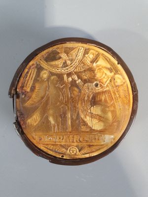 an image of a gold plate with an image of a man and a woman on it