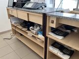 a counter with a laptop and a printer on top of it