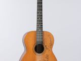 a close up of an acoustic guitar on a white background