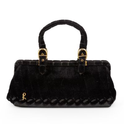 a black handbag with braid handles on a white background