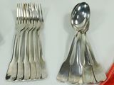 a lot of silver spoons and forks on a table