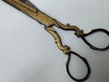 a pair of scissors sitting on a white surface