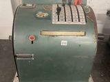 a green machine that is sitting on the floor