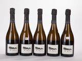 six bottles of wine are lined up in a row on a white surface