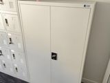 a white cabinet in the corner of a room