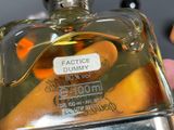 someone is holding a bottle of perfume with a label on it