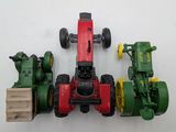 three toy tractors that are sitting next to each other