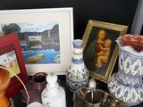 many different vases and pictures on the table