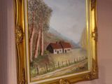 a painting on the wall above a bed in a bedroom