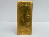 a close up of a gold bar on a white surface