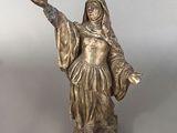 a statue of a woman that is standing on a table