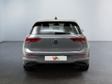 the rear end of a silver volkswagen v - cross parked in a white room