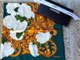 chanel scarf with gold and white roses on a green background