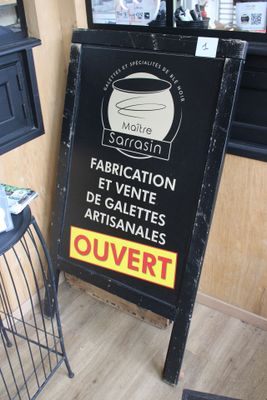 a sign for a coffee shop on the side of the street