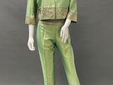 a mannequin wearing a green suit with gold trimmings