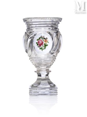 a glass vase with a flower on it on a table