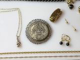 many necklaces and bracelets laid out on a table