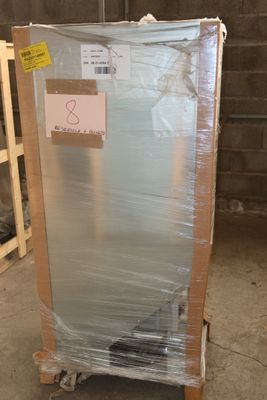 a refrigerator that is wrapped in plastic and ready to be shipped