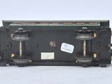 three small black and gold train cars sitting side by side