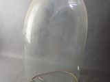 a clear glass vase with a gold wire around it
