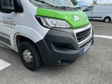 a green and white van that is parked in a parking lot