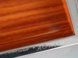 a close up of a wooden table with a silver plate on it