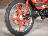 a close up of a motorcycle with a red tire