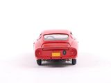 a red toy car that is sitting on a white surface