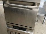 a stainless steel dishwasher in the middle of a kitchen