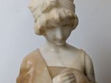 marble statue of a woman holding a baby in her arms