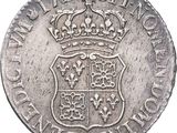 a close up of a silver coin with a crown on it