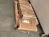 a pile of boxes sitting on the floor next to a refrigerator