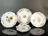 three plates with floral designs on them sit on a table
