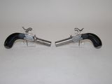 pair of black and silver revolvers on a white surface