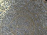 a close up of a metal tray with a design on it