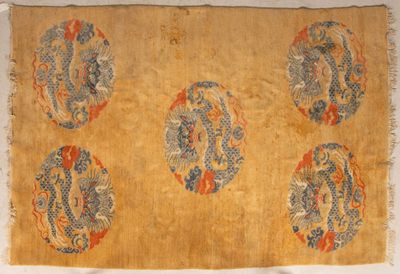 an old chinese rug with four dragon designs on it