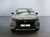 the front view of a grey car parked in a showroom