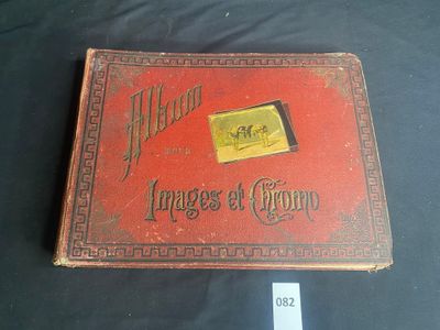 an old red book sitting on top of a black table