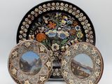 two plates with a picture of a mountain scene on them and a plate with a picture of a mountain scene on it