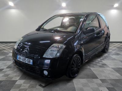 a picture of a small black car on a checkered floor