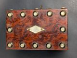 leather box with brass studs and rivets on a black background